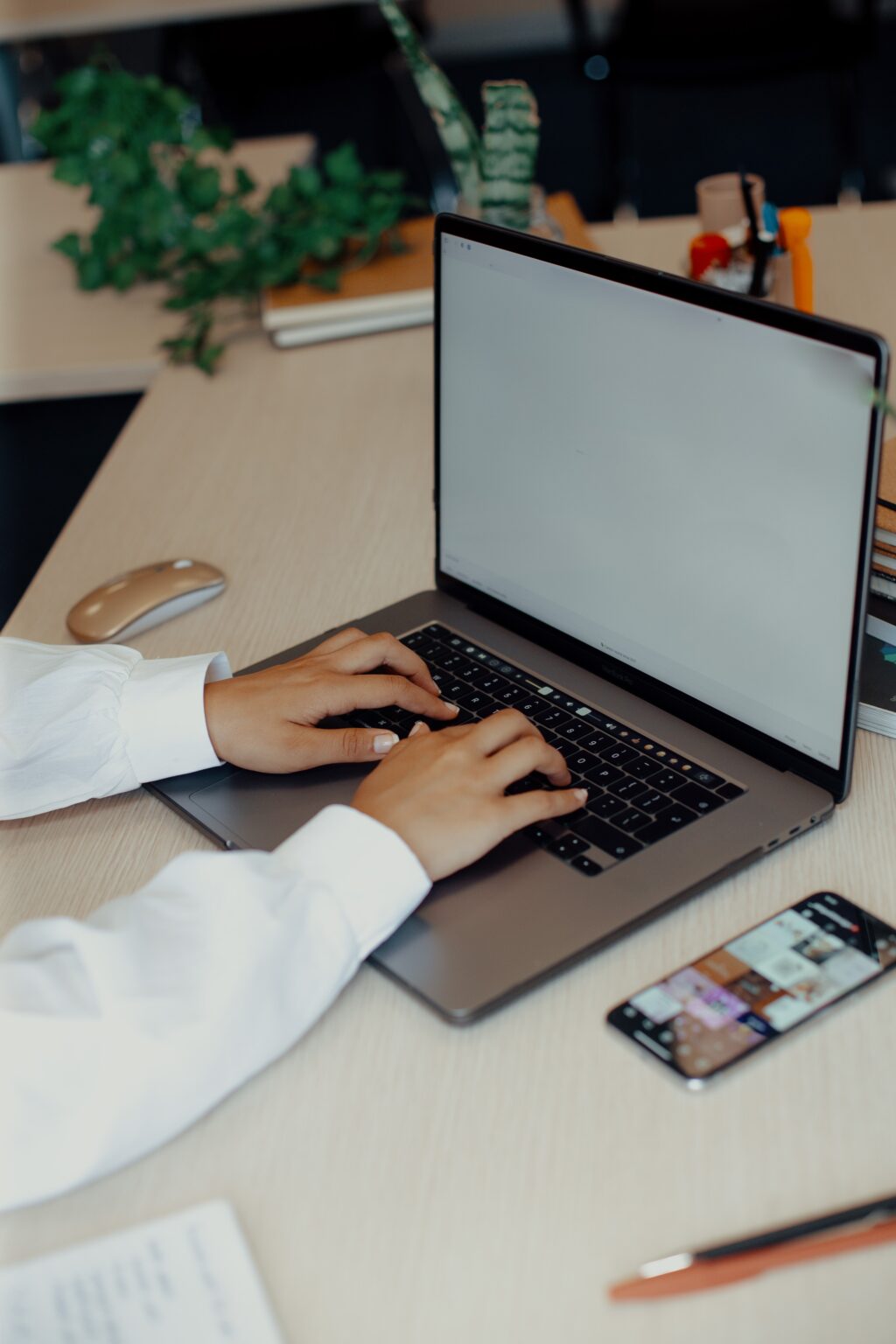 Person typing on a laptop keyboard